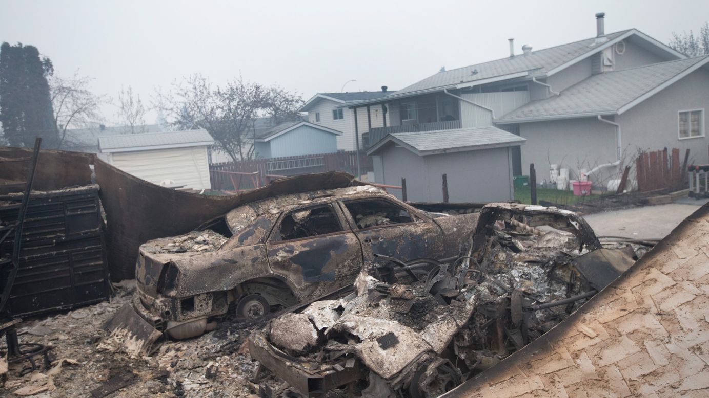 Charred vehicles sit in a heavily damaged residential neighborhood on May 7. 