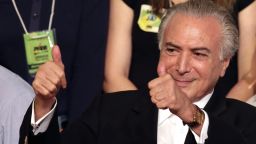 FILE - In this March 12, 2016, file photo, Brazil's Vice President Michel Temer flashes two thumbs up during the Brazilian Democratic Movement Party, national convention in Brasilia, Brazil. The son of Lebanese immigrants, Temer is one of the countrys least popular politicians but has managed to climb his way to the top, in large part by building close relationships with fellow politicians as leader of the large but fractured Brazilian Democratic Movement Party. (AP Photo/Eraldo Peres, File)