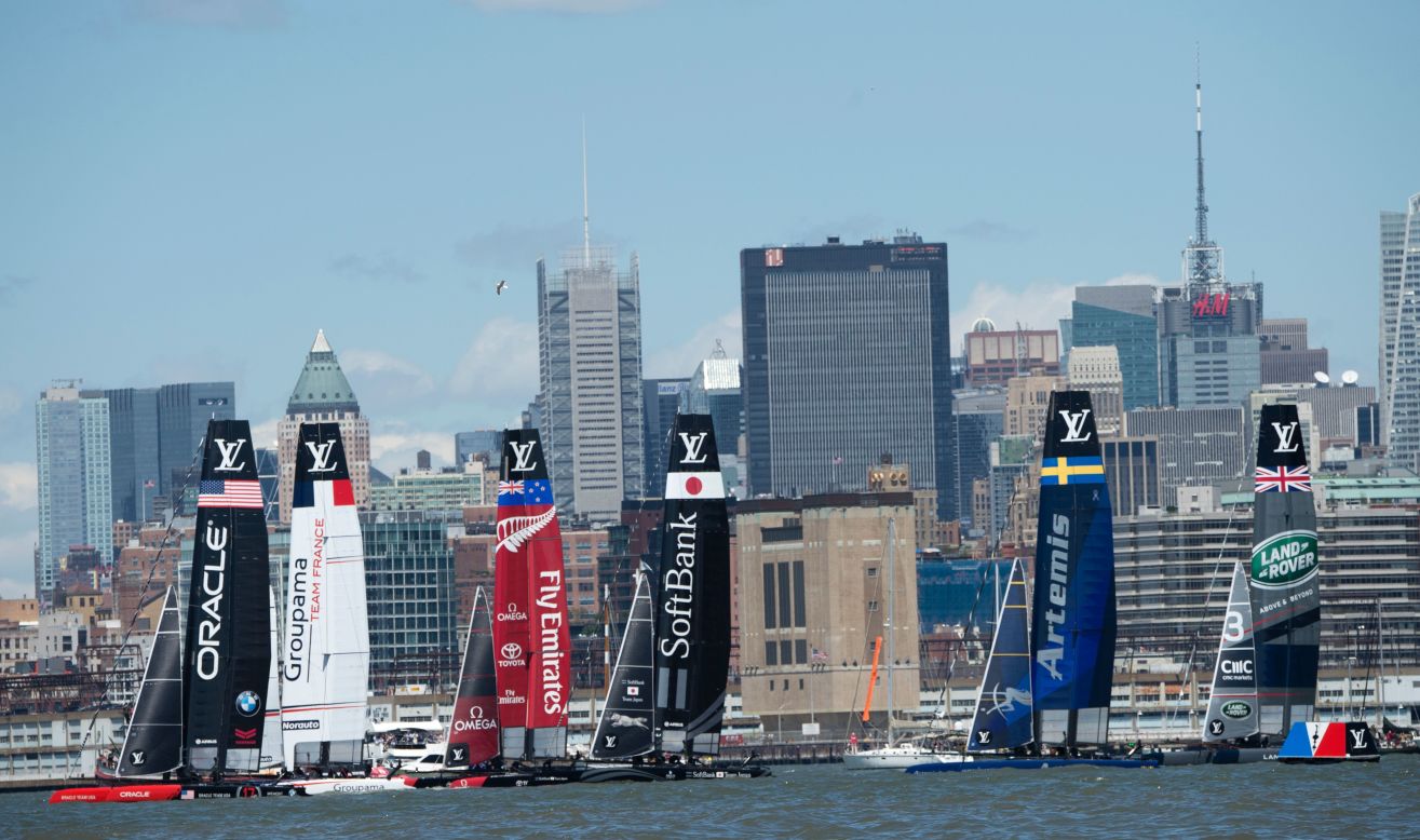 Sailboats maneuver for position during the start of the first race on Sunday.