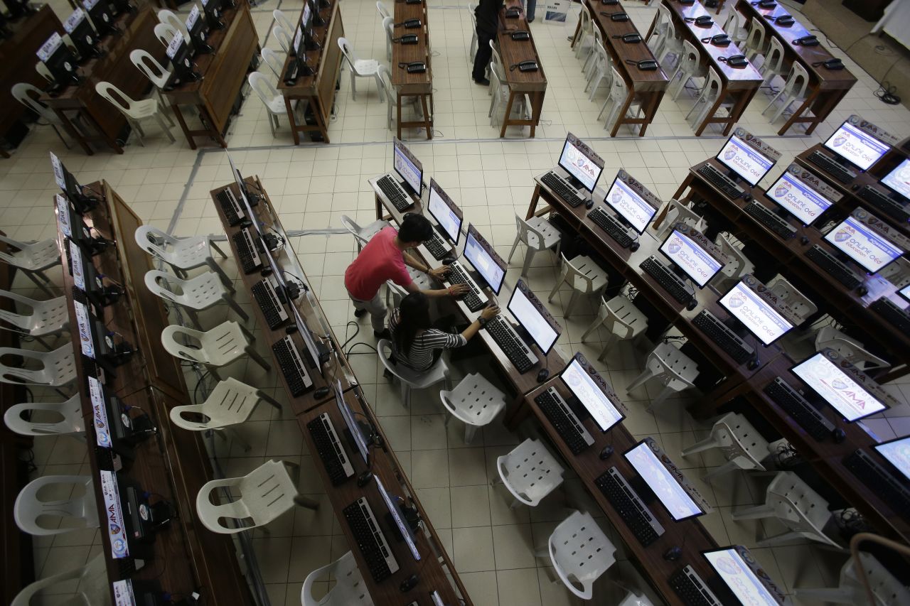 Workers check computers at the command center of the church-backed election watchdog Parish Pastoral Council for Responsible Voting (PPCRV) in Manila, Philippines on the eve of election day, Sunday, May 8, 2016. 