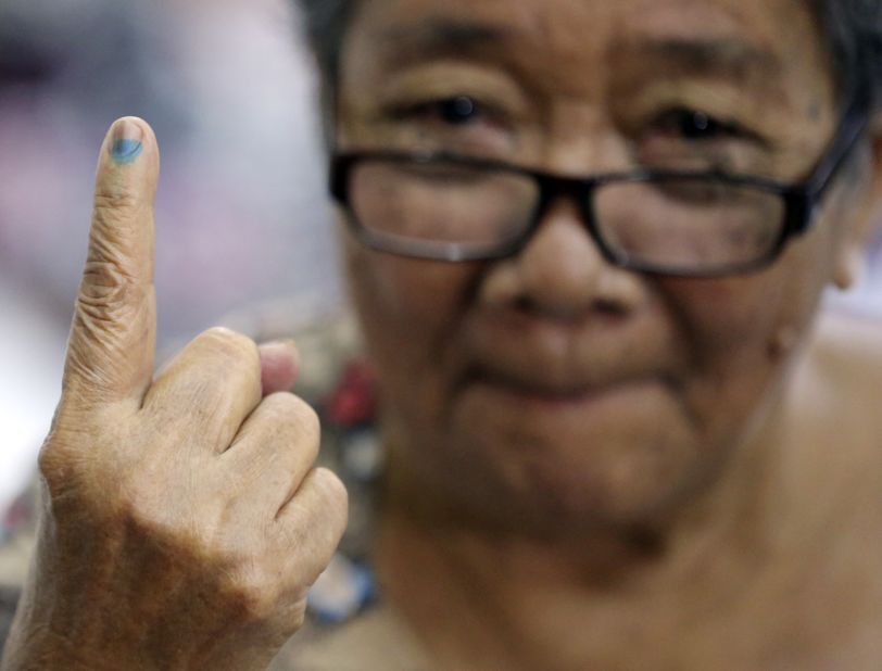 Esteban shows the indelible ink on her finger after casting her vote.