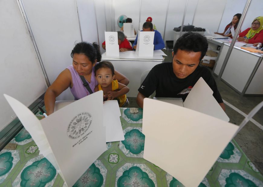 People fill out ballots on Monday, May 9, 2016. The front-running presidential candidate is the foul-mouthed, crime-busting mayor Rodrigo Duterte. 