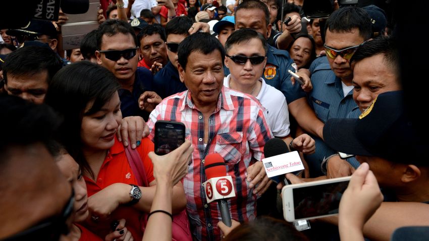 Presidential frontrunner and Davao City Mayor Rodrigo Duterte leaves the voting precint after casting his vote at Daniel Aguinaldo National High School in Davao City, on the southern island of Mindanao on May 9, 2016.