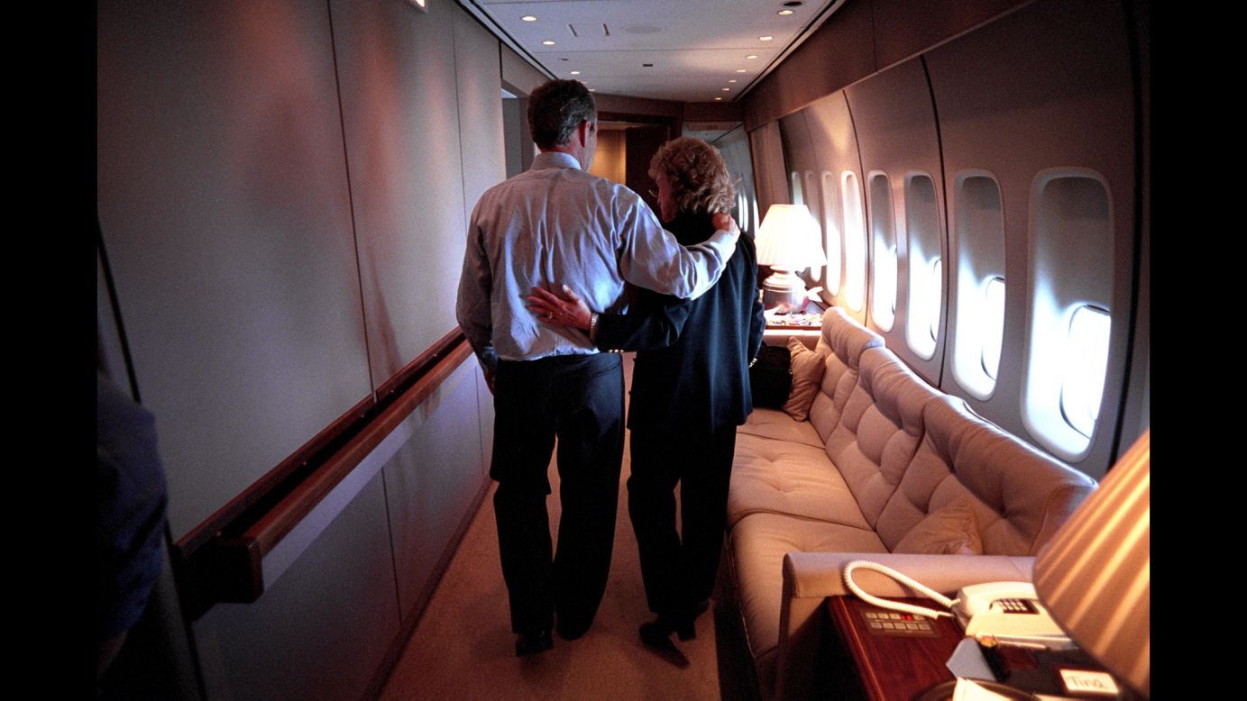 Bush and White House Staff Secretary Harriet Miers walk through Air Force One en route to Washington.