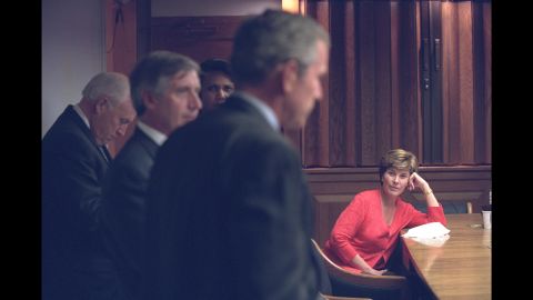 First lady Laura Bush listens as Bush discusses the terrorist attacks with White House staff in the President's Emergency Operations Center.