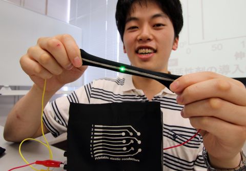 Naoji Matsuhisa, a doctoral student of Japan's University of Tokyo, demonstrates a printed elastic electric conductor on a fabric which can be stretched to more than three times its original length. This technology can be used to make wearable devices embedded with biometric sensors.  