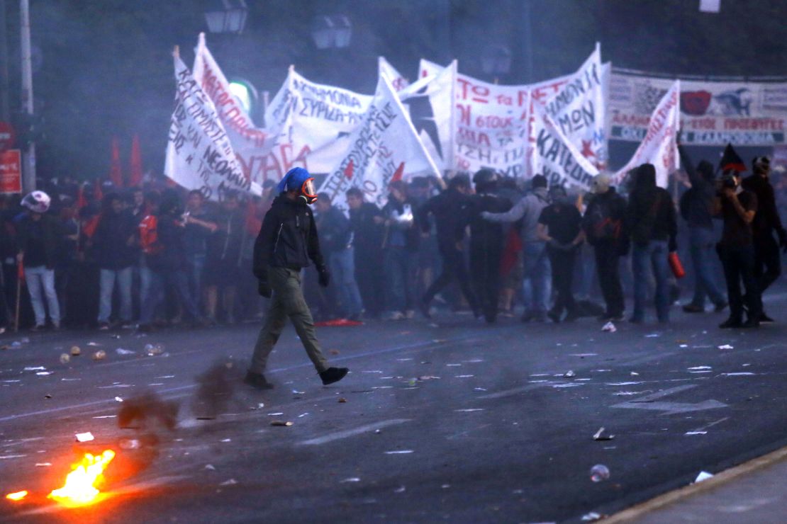 Protesters try to escape tear gas during clashes on May 8, 2016 in Athens, Greece.