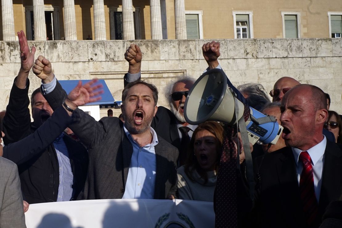 Fits in the air, protesters chant anti-austerity slogans in Athens, May 8, 2016.
