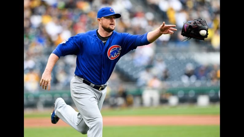 Chicago Cubs pitcher Jon Lester tosses his glove to first base -- with the ball stuck in it -- after fielding a ball in Pittsburgh on Wednesday, May 4.