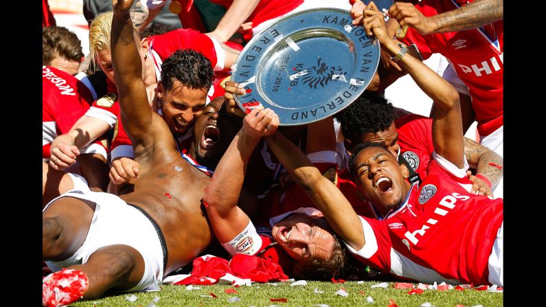 Soccer players from PSV Eindhoven celebrate together after winning the Dutch league in Zwolle on Sunday, May 8. It is the 23rd league title for PSV, which also won last season.