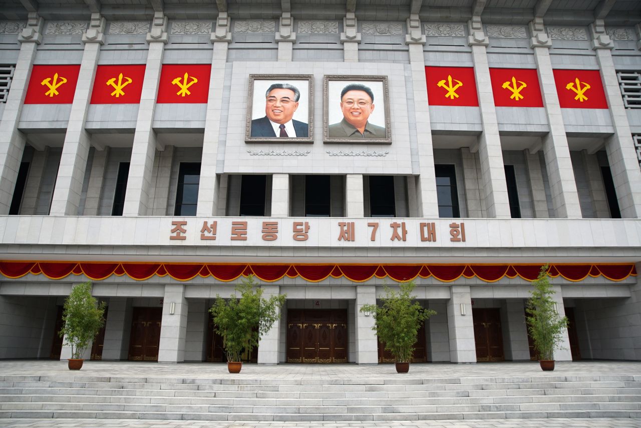 The images of former North Korean leaders Kim Il Sung (left) and Kim Jong Il hang outside the April 25 House of Culture as Pyongyang holds its 7th Congress of Workers' Party.