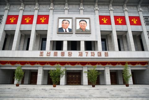 The images of former North Korean leaders Kim Il Sung (left) and Kim Jong Il hang outside the April 25 House of Culture as Pyongyang holds its 7th Congress of Workers' Party.