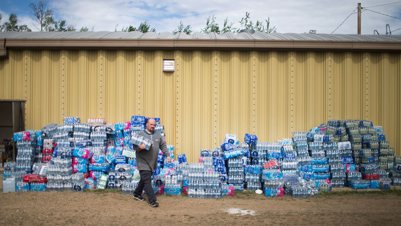 Rodney Howse gets water at a donation center on May 8. The center was established to help evacuees who were forced from their homes by the wildfire.