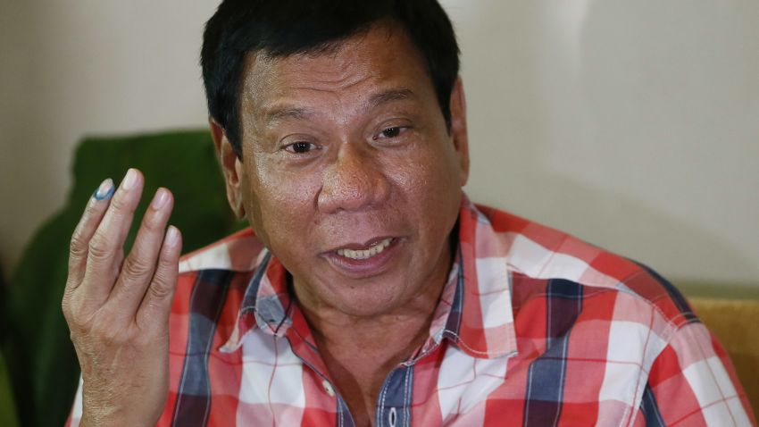 Front-running presidential candidate Mayor Rodrigo Duterte gestures during his second news conference after voting in a polling precinct at Daniel R. Aguinaldo National High School, Matina district, his hometown in Davao city in southern Philippines Monday, May 9, 2016. Duterte was leading by a wide margin in unofficial tallies but still refuses to claim victory. (AP Photo/Bullit Marquez)