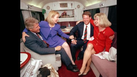 During the 1992 presidential campaign, Clinton jokes with her husband's running mate, Al Gore, and Gore's wife, Tipper, aboard a campaign bus.