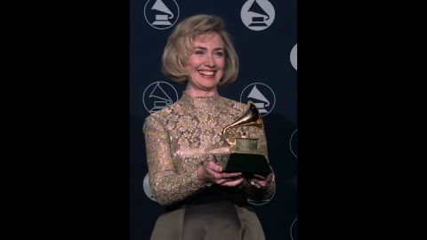 The first lady holds up a Grammy Award, which she won for her audiobook "It Takes a Village" in 1997.