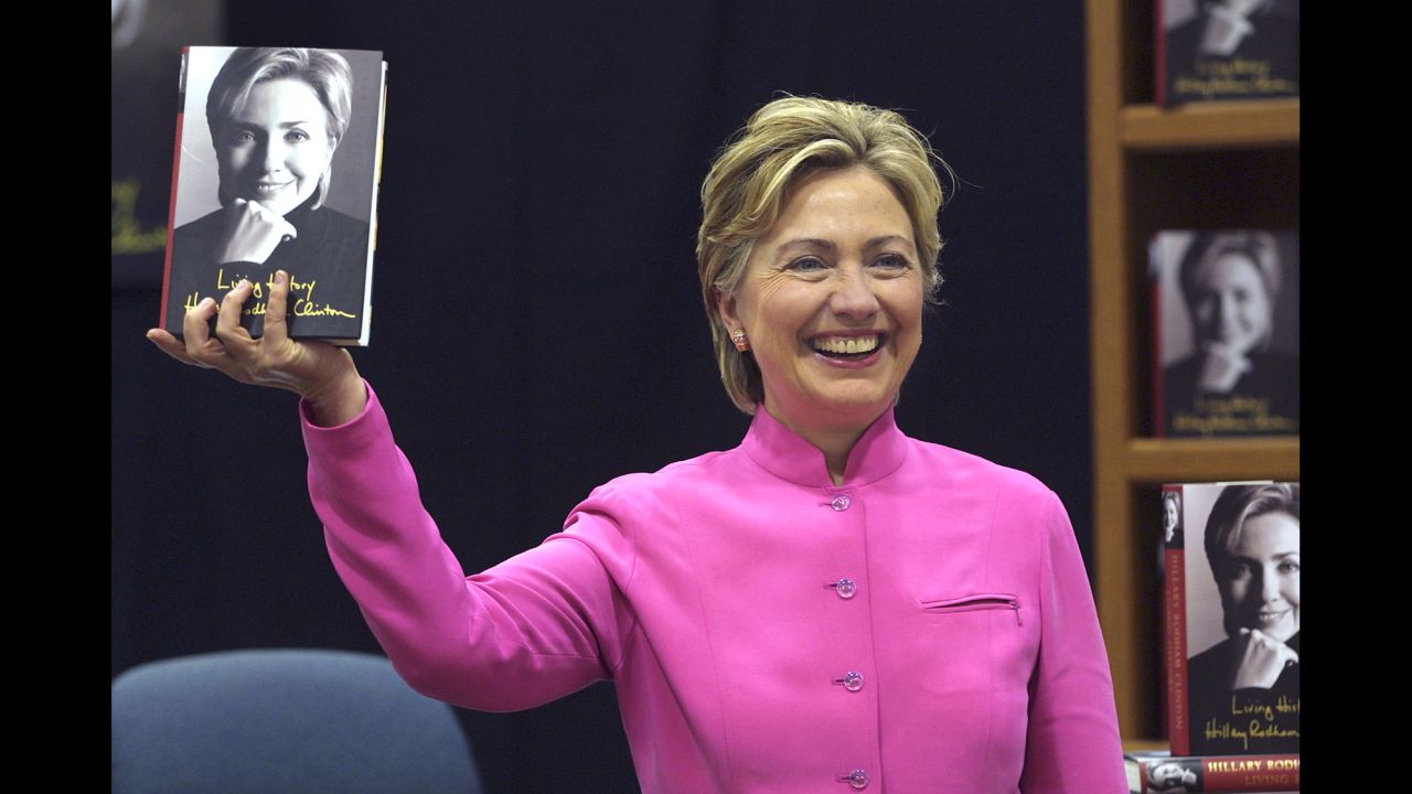 Clinton holds up her book "Living History" before a signing in Auburn Hills, Michigan, in 2003.