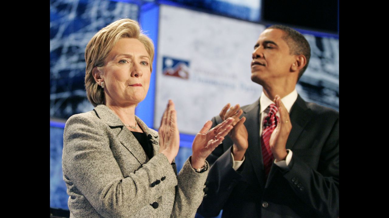 Clinton and another presidential hopeful, U.S. Sen. Barack Obama, applaud at the start of a Democratic debate in 2007.