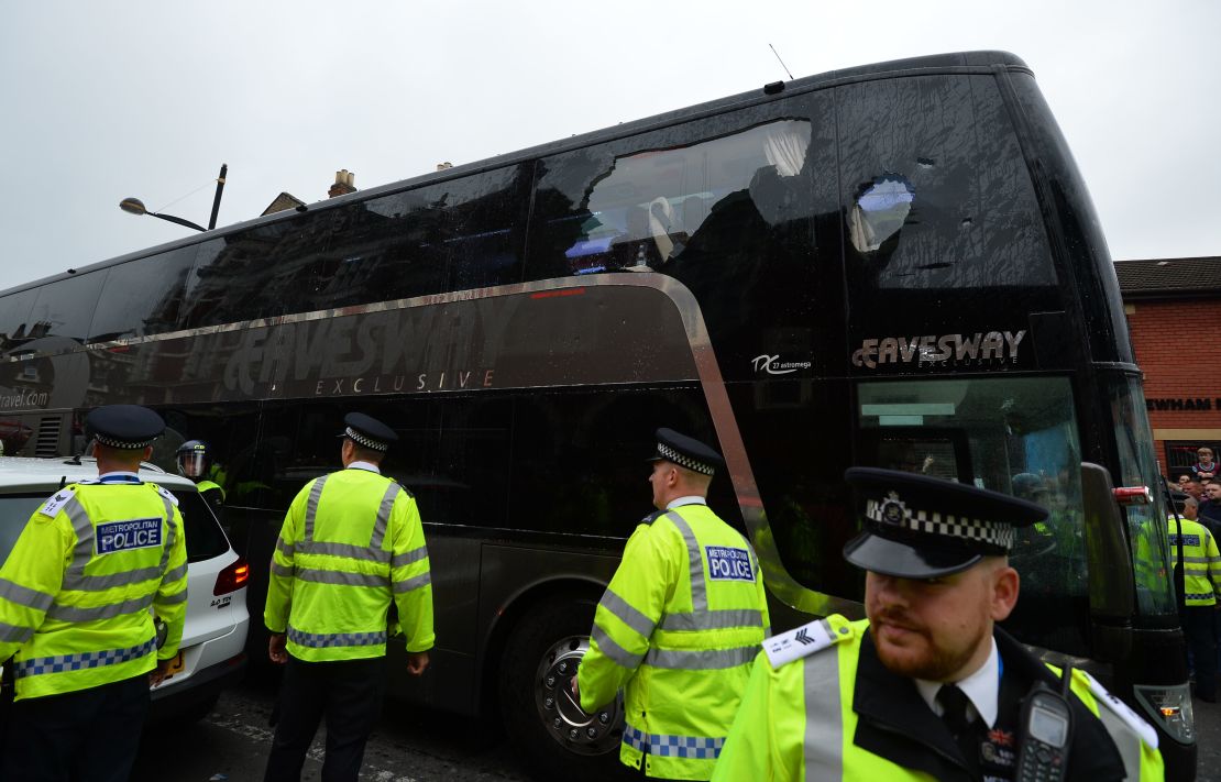The bus carrying the Manchester United team is escorted by police after having a window smashed on its way to West Ham's Boleyn ground