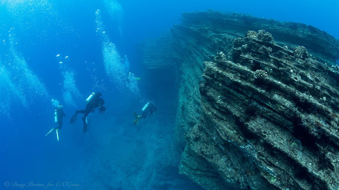The underwater seascape has vertical walls and spires that plunge precipitously to depths of hundreds of feet.