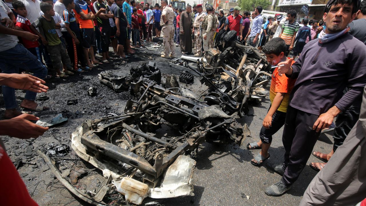 A crowd looks at the damage following a car bomb attack in Sadr City, a Shiite area north of the capital Baghdad.