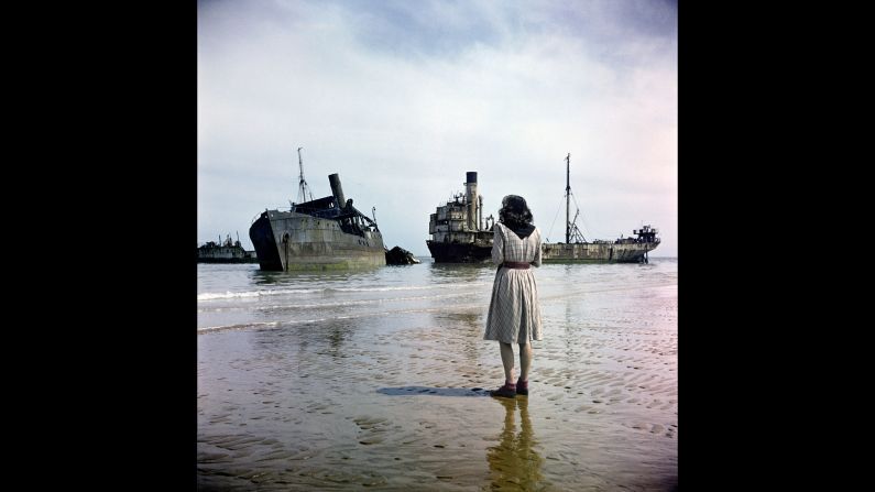 A woman walks on Omaha Beach in 1947, three years after the Allied forces invaded German-occupied France during World War II. The photo was taken by David Seymour, a famous Polish photographer also known as Chim. These color images, recently scanned and never seen before, follow the route the Allies took as they drove toward Berlin.