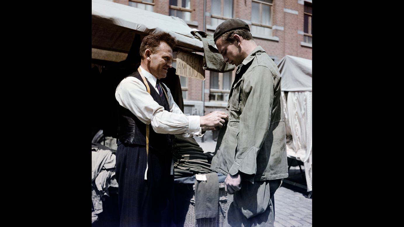 Discarded U.S. Army clothing is worn in Bastogne, Belgium, in 1947.