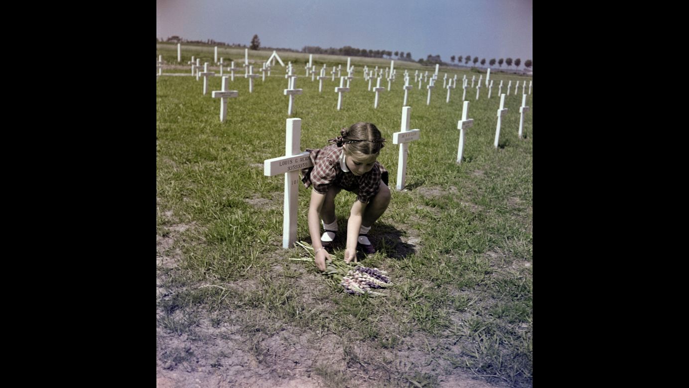 A girl lays flowers at a U.S. cemetery in Margraten, Netherlands, in 1947. It is now the Netherlands American Cemetery and Memorial.