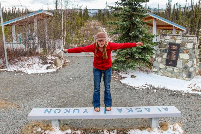 Along the Alaska Highway you can straddle the U.S.-Canada border.