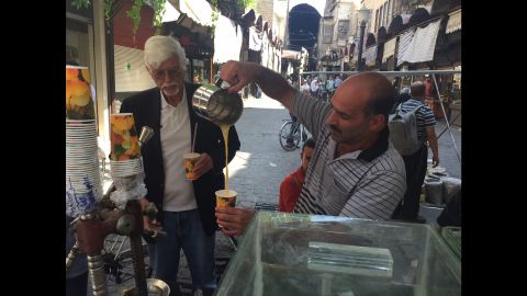 Thomas Webber paused to buy fresh-pressed orange juice from a street vendor in Damascus.
