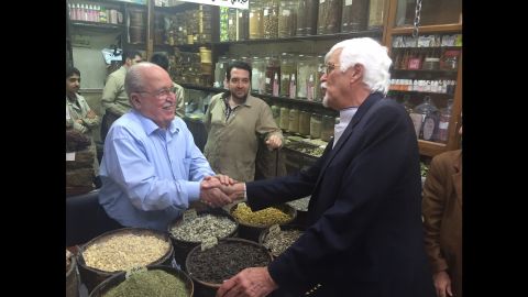 Thomas Webber greets the owner of a shop in Damascus that sells spices and herbal remedies. The same family has owned the shop for 200 years.