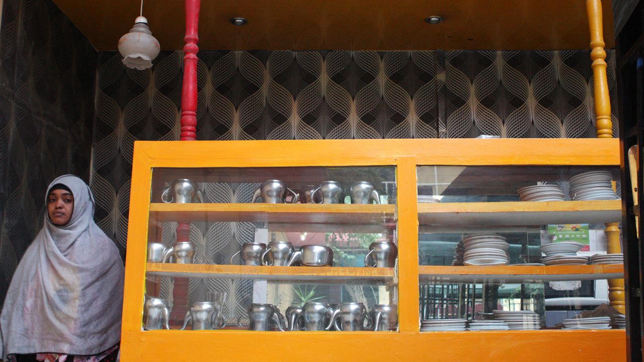 The Oriental's collection of stainless steel teapots is stacked in a cabinet in the courtyard bar. According to one guest, all of the teapots have long since lost the hinges that attach their lids.