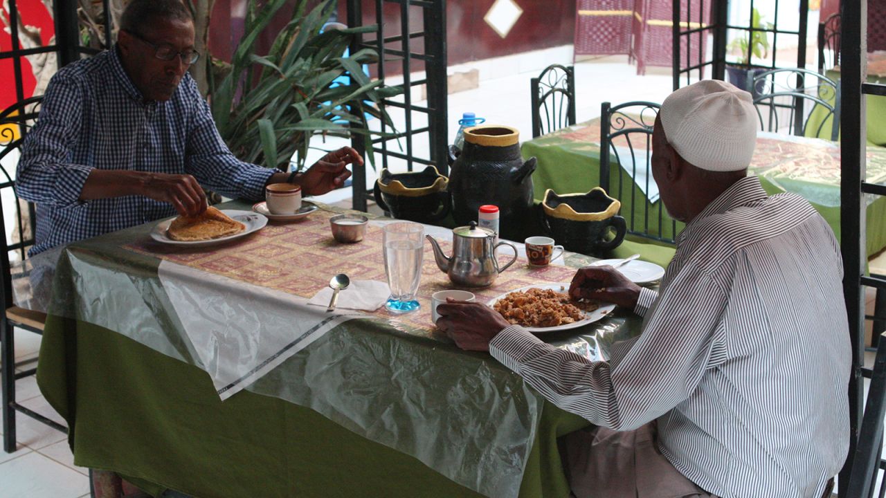 British Somalilanders visiting from the UK, Jirdeh Farar (left) and Mohamud Hassan (right), enjoy breakfast. Both are Oriental regulars, often staying for more than a month at a time at the hotel.