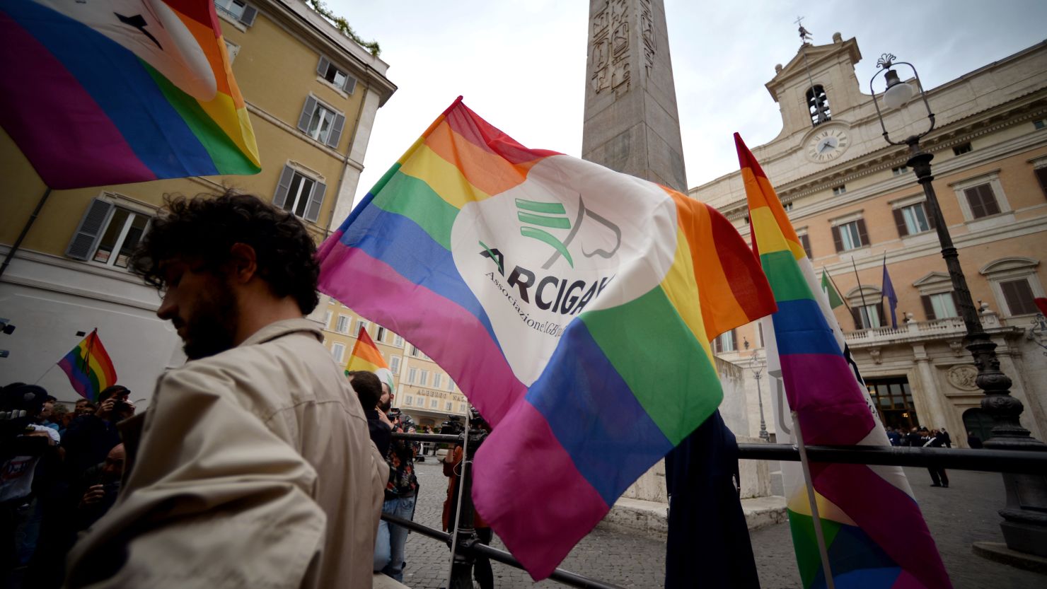 Supporters of same-sex civil unions stand outside the Italian Parliament in Rome on May 11, 2016. 