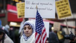 A Muslim woman holds a poster during a protest  against Donald Trump on December 20, 2015 in New York. Republican presidential hopeful Donald Trump proposed a call for a ban on Muslims entering the United States. AFP PHOTO/KENA BETANCUR / AFP / KENA BETANCUR        (Photo credit should read KENA BETANCUR/AFP/Getty Images)