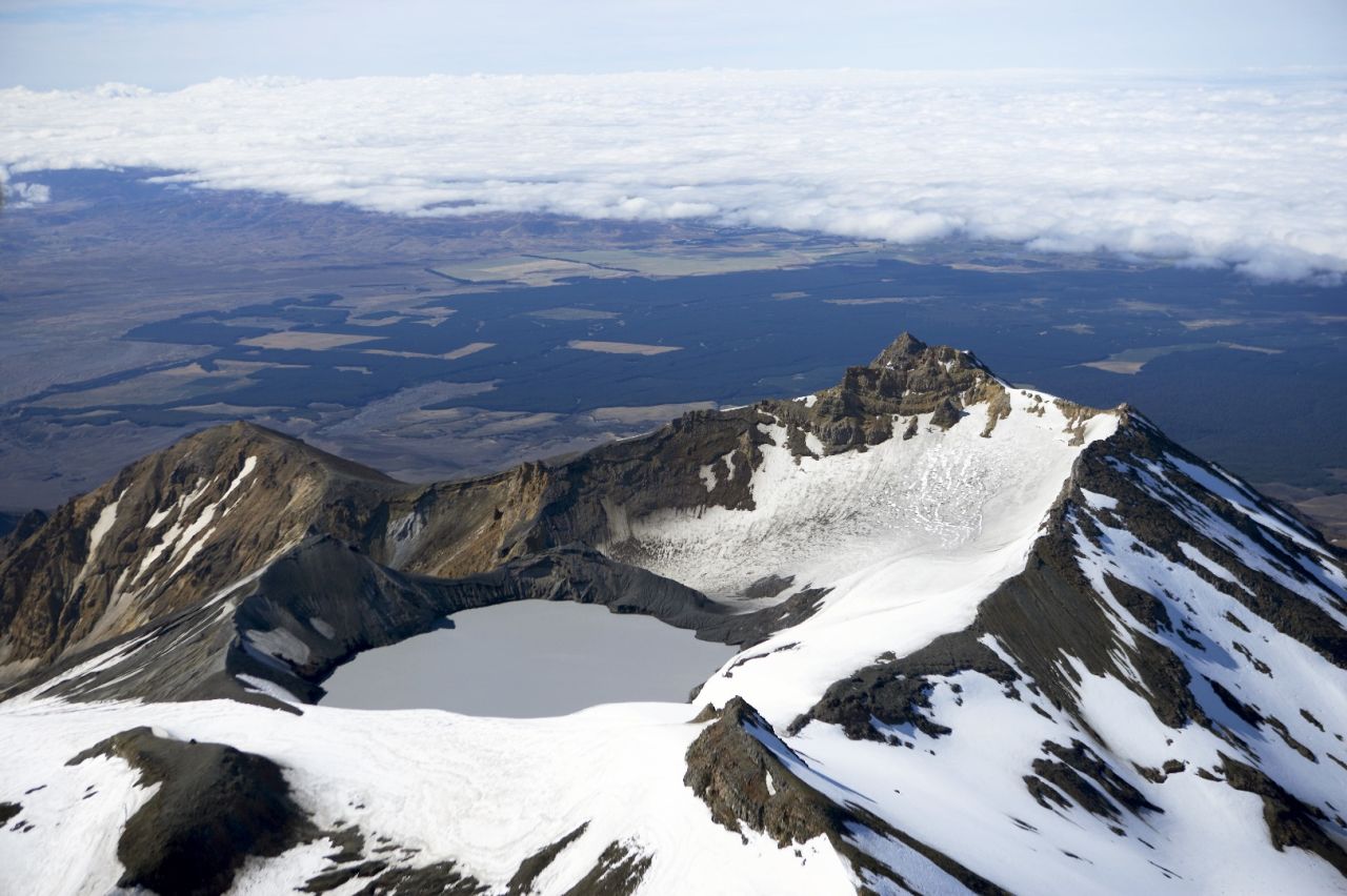 View of crater lake covered in snow.