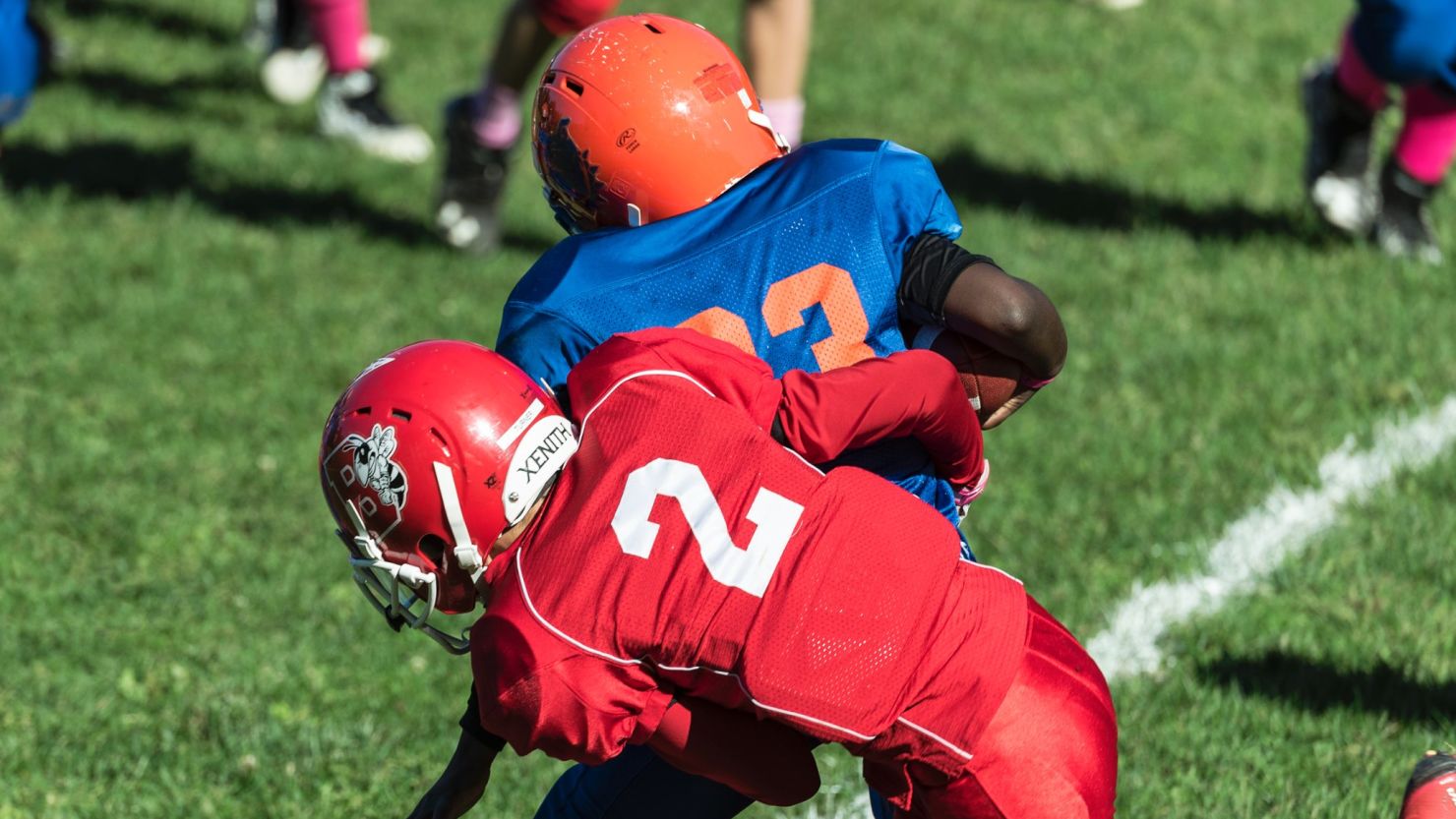 A player makes a tackle during a Pop Warner football game in Syracuse, New York. 