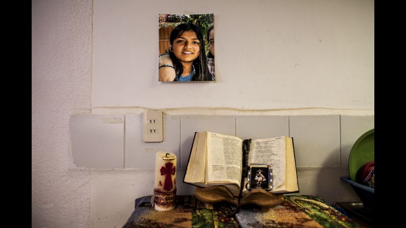An altar is set in a home living room for Amanda, a 16-year-old who never came home from school in 2012. Every night, her father and sisters pray for her, said photographer Nuria Lopez Torres.