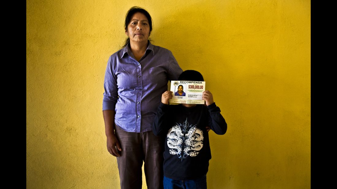 Tadeo, 7, holds a flyer next to his grandmother, Rosa Maria. Tadeo's mother, Fabiola, was kidnapped in 2012 when she left for a job interview.