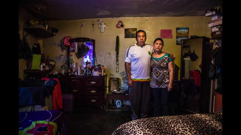Lorena Ivonne's parents pose for a photo in her room. The 25-year-old disappeared in September when she left the house to go to work. She and her son were living with her parents after a divorce.