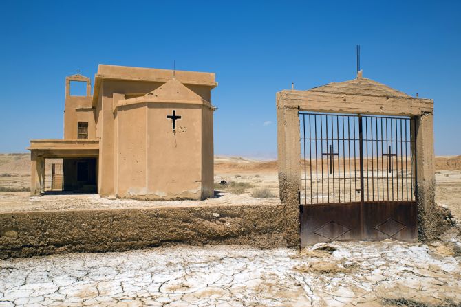 The Syrian Orthodox church, though deserted, remains in the best condition of the seven churches at the site. Bullet holes mark its facade, and mortar shells pepper the field surrounding it. 