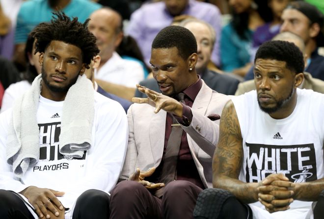 Winslow (left), is currently a bench player but has logged heavy minutes in the Heat's playoff run. He is pictured sitting with injured Heat star Chris Bosh (center) and veteran Udonis Haslem. 