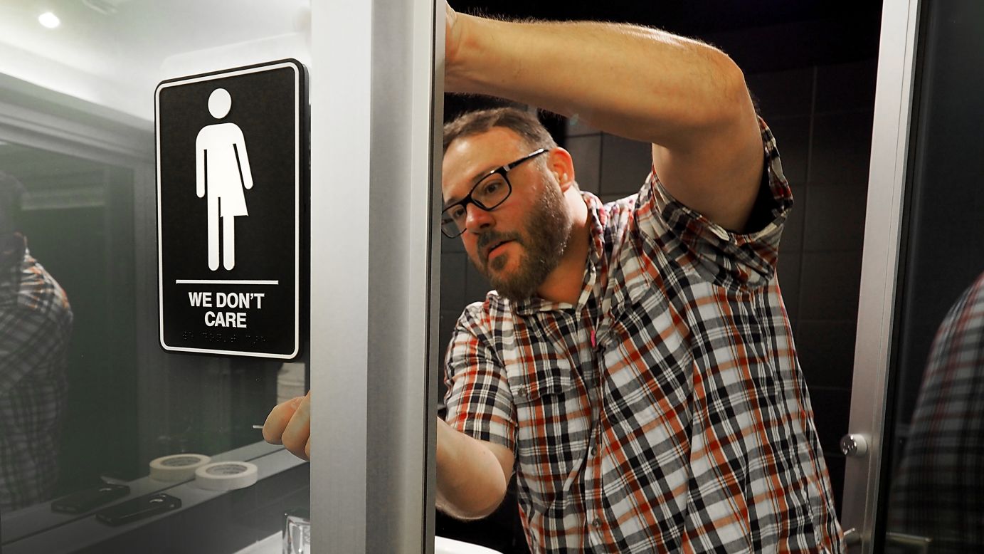 Manager Jeff Bell applies a gender-neutral sign inside a public restroom at the 21C Museum Hotel in Durham, North Carolina, on Tuesday, May 10. The U.S. Justice Department <a href="http://www.cnn.com/2016/05/09/politics/north-carolina-hb2-justice-department-deadline/" target="_blank">has filed a civil rights lawsuit</a> over the state's so-called bathroom bill, which bans people from using public bathrooms that do not correspond with their biological sex. Since its passage in March, North Carolina has become a national battleground on the issue of transgender rights.