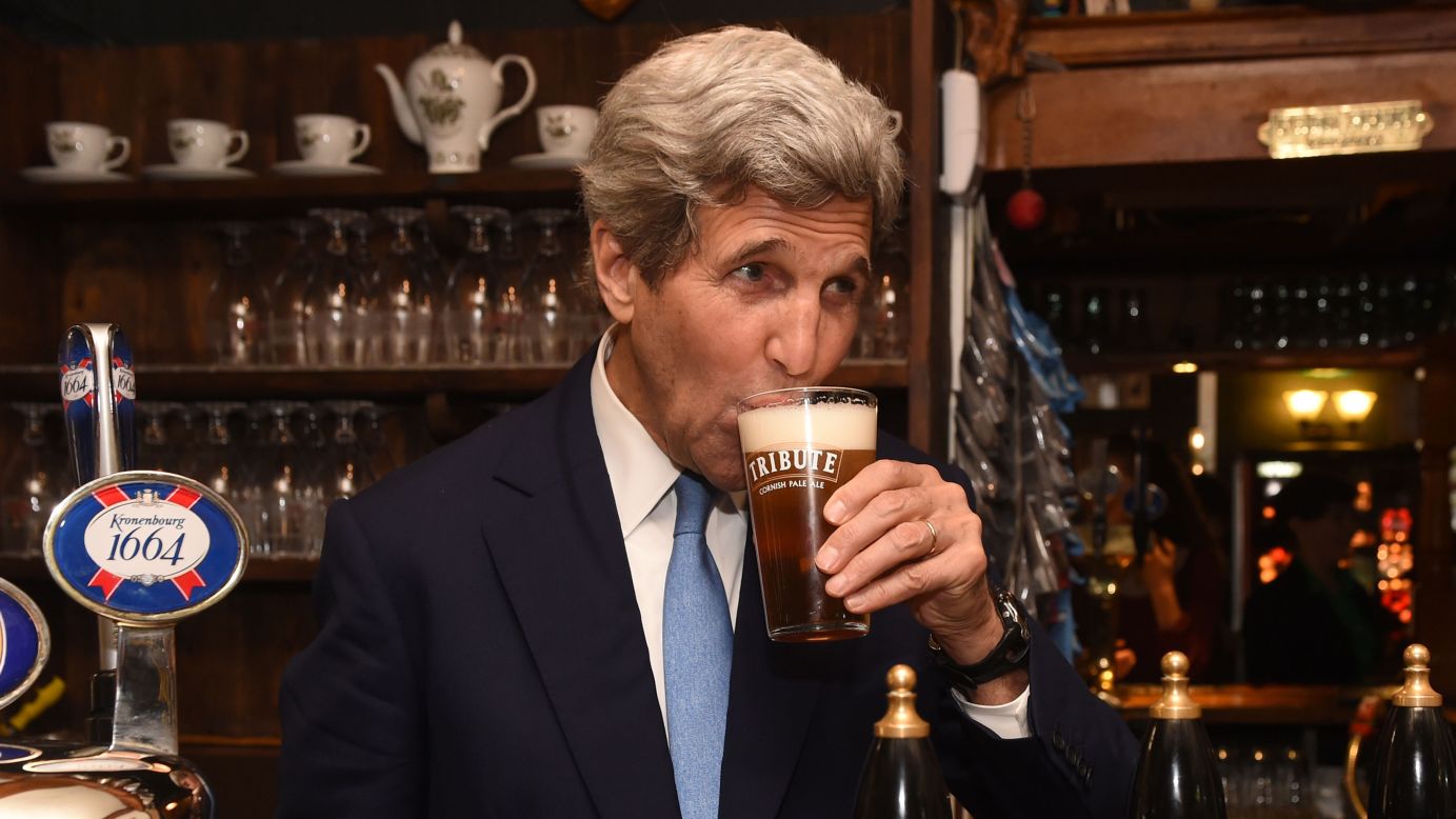 U.S. Secretary of State John Kerry sips a pint of beer while visiting Oxford, England, on Wednesday, May 11.
