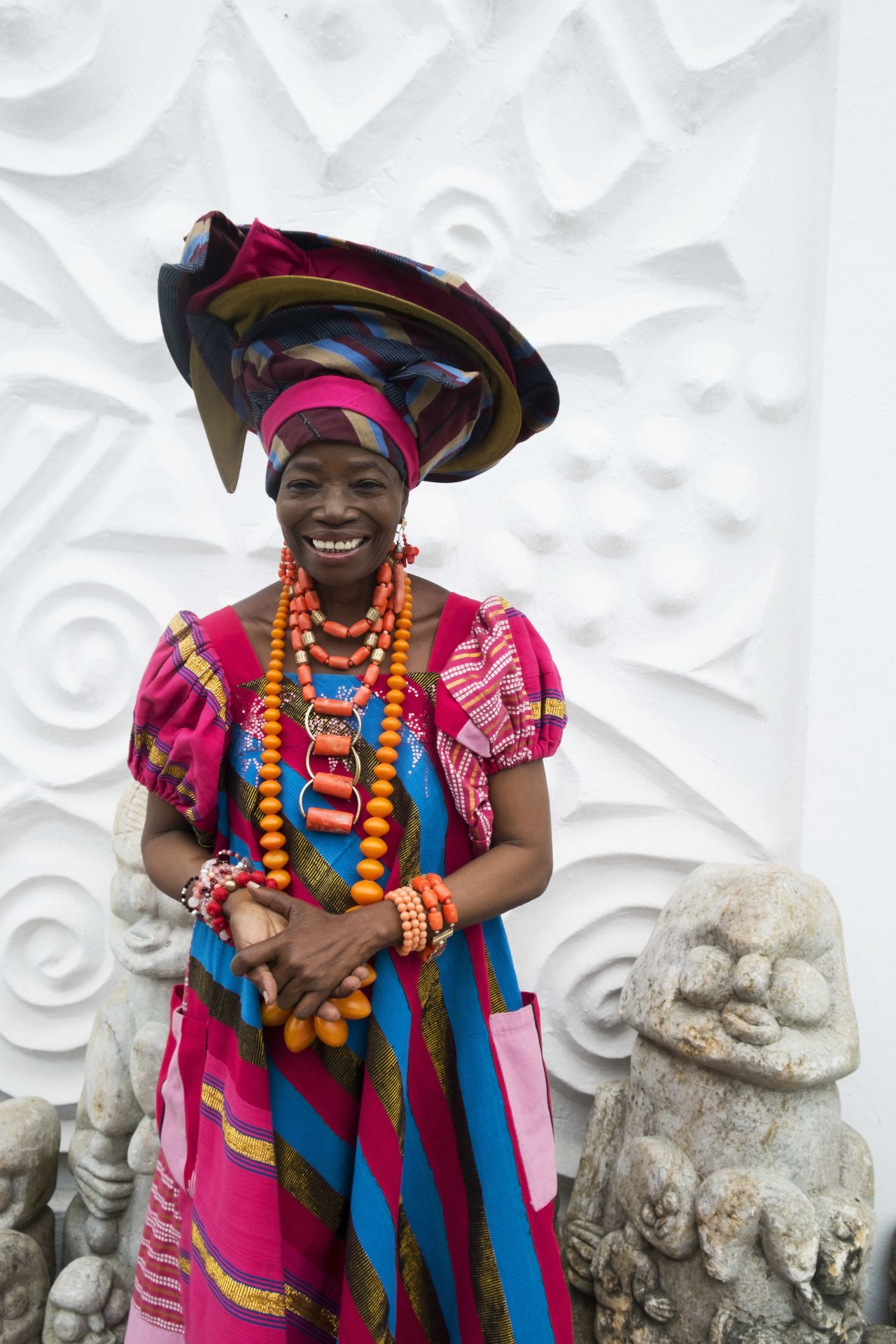  Africa's most populous city is known for its flamboyancy. "Wallflowers need not apply", writes Helen Jennings, journalist and former editor of African fashion magazine Arise. Women mix African and European styles by wearing tailored dresses with the gele, a traditional African head wrap. <br />Pictured: Lagos, Nigeria - Nike Davis Okundaye, Nike Art Centres
