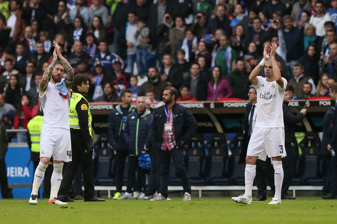 Real Madrid's defenders Sergio Ramos and Pepe applaud their fans at the end of the 2-0 win at Deportiva La Coruna, but their side had to settle for second place in La Liga. 
