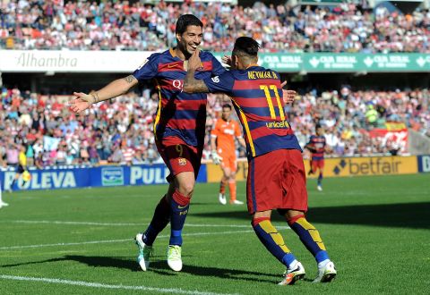 Suarez embraces Neymar after completing his hat-trick at Granada and his 40th league goal of the season.