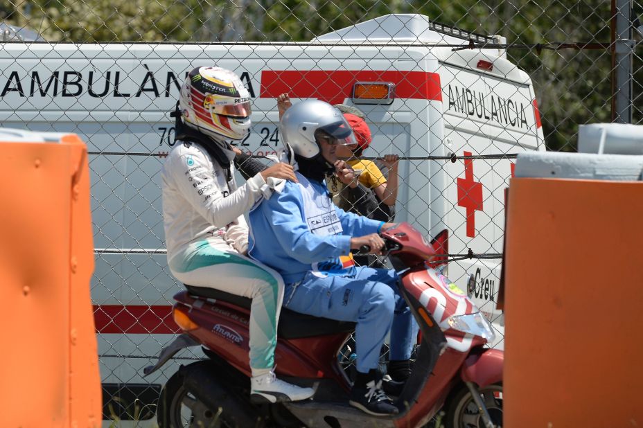 Hamilton swapped four wheels for two, as he was escorted back to Mercedes' base on a scooter following the crash.