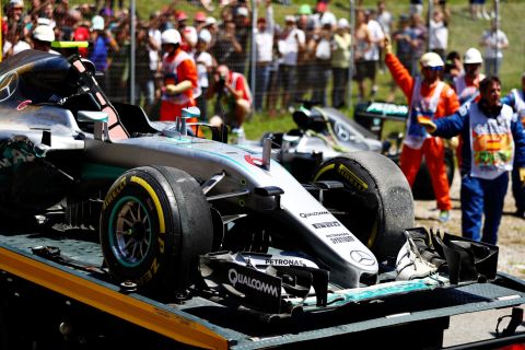 Rosberg's car is towed away from the side of the track following the collision.