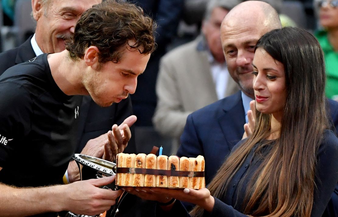 Murray is given a cake after his win to celebrate his 29th birthday